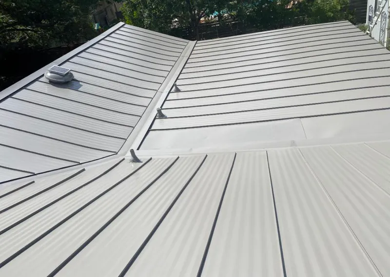 Solar attic fan installed on a metal roof for Roof Ventilation in South Burlington